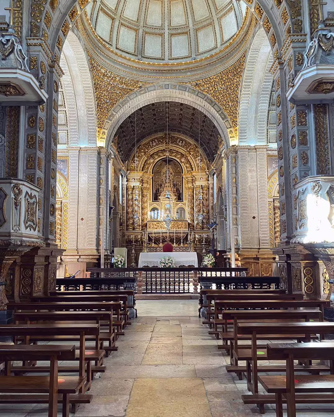 Interior of ornate church in Nazaré, Portugal, showcasing intricate architecture and historical charm near the giant waves surf experience.