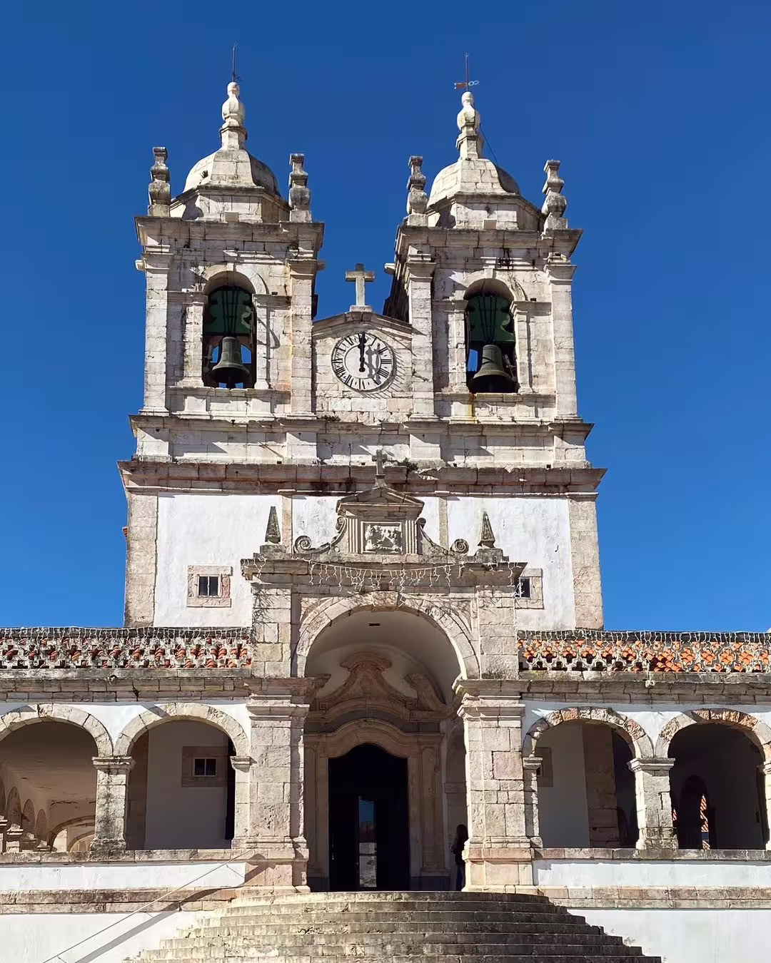 Historic church in Nazaré with twin bell towers and ornate architecture, capturing the cultural charm of this surfing destination.