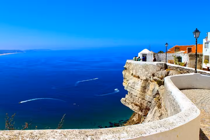 Stunning coastal view of Nazaré with deep blue ocean, included in the private tour from Lisbon.
