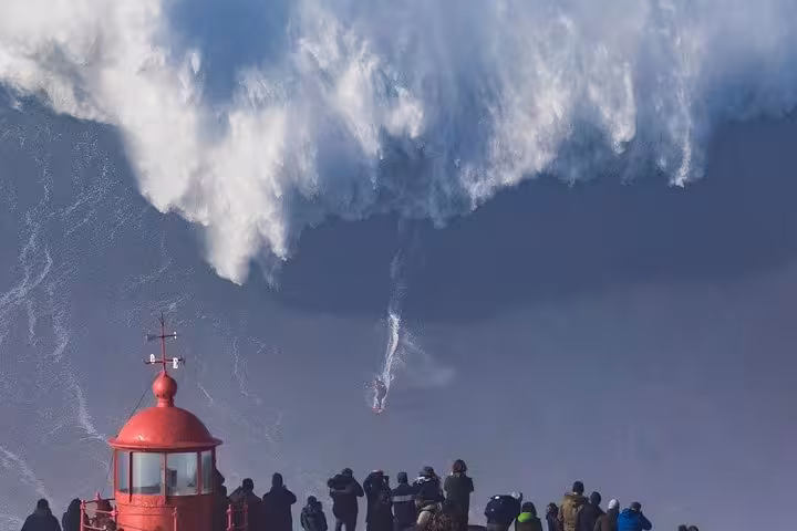 Nazaré giant waves viewpoint stop on Lisbon to Porto private transfer, lighthouse and ocean surf scene