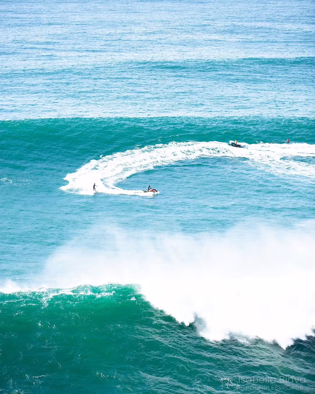 Surfers ride massive waves at Nazaré, Portugal, showcasing thrilling ocean adventure in this epic surf experience photo.