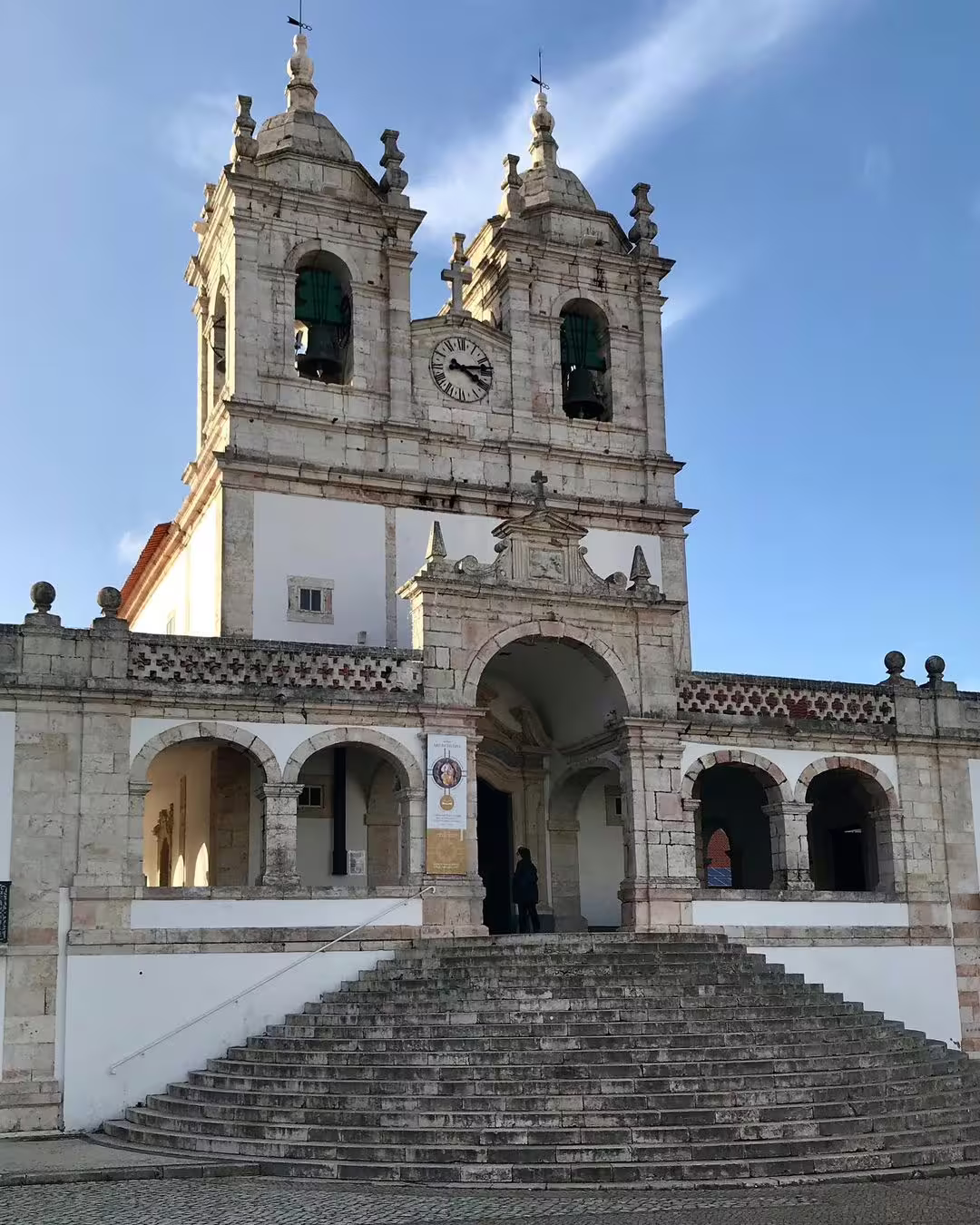 Historic church in Nazaré with twin bell towers, a popular cultural stop before experiencing the giant waves surf adventure.
