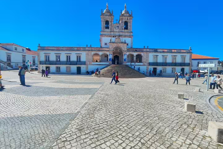 Visitors exploring the historic Sanctuary of Our Lady of Nazaré, a key highlight in Portugal's cultural tour.