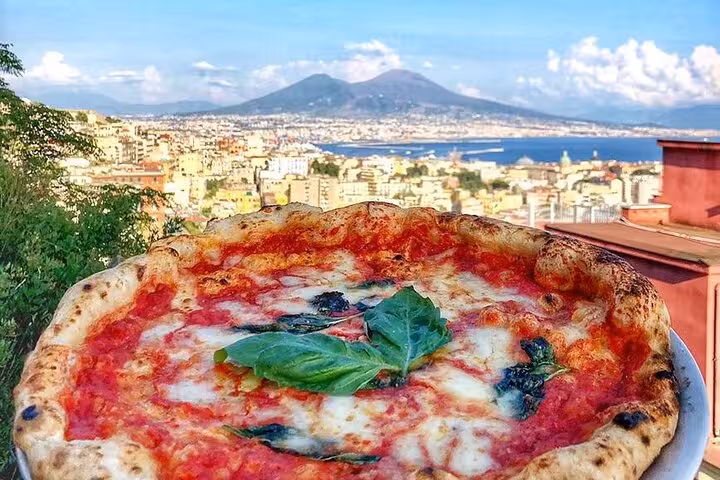 Authentic Neapolitan pizza with scenic view of Naples and Mount Vesuvius, highlighting the flavors of Italy.