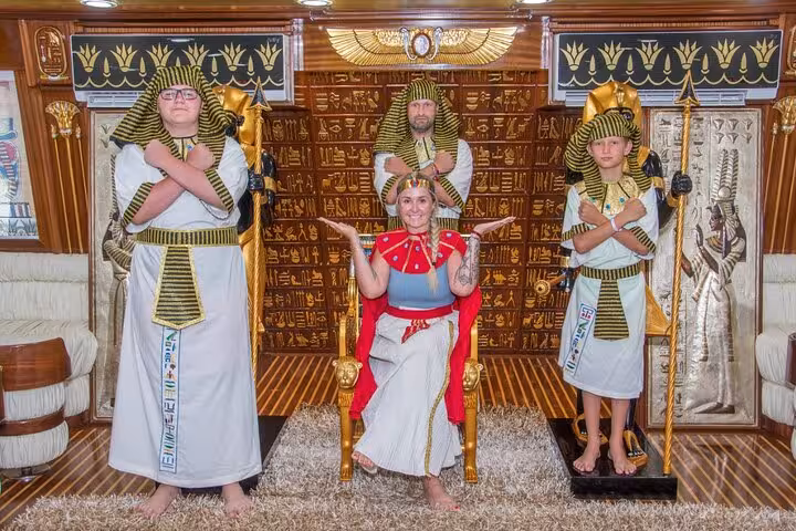 Tourists pose in ancient Egyptian costumes on Nefertari Cruise Marsa Alam, onboard show with dinner and pickup