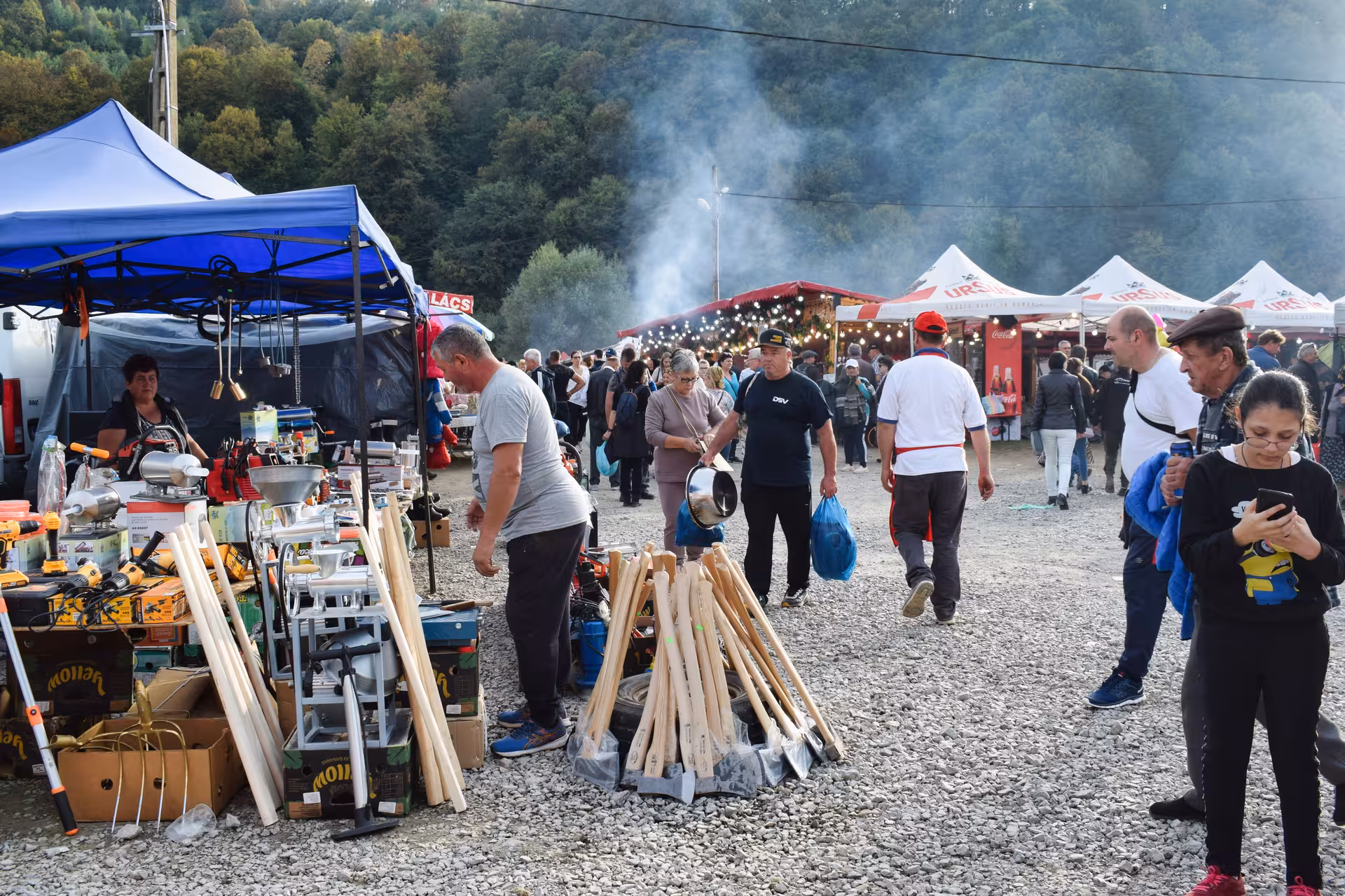 Bustling Negreni Flea Market outdoor stalls with tools antiques and crowds amid smoky food vendors Romania