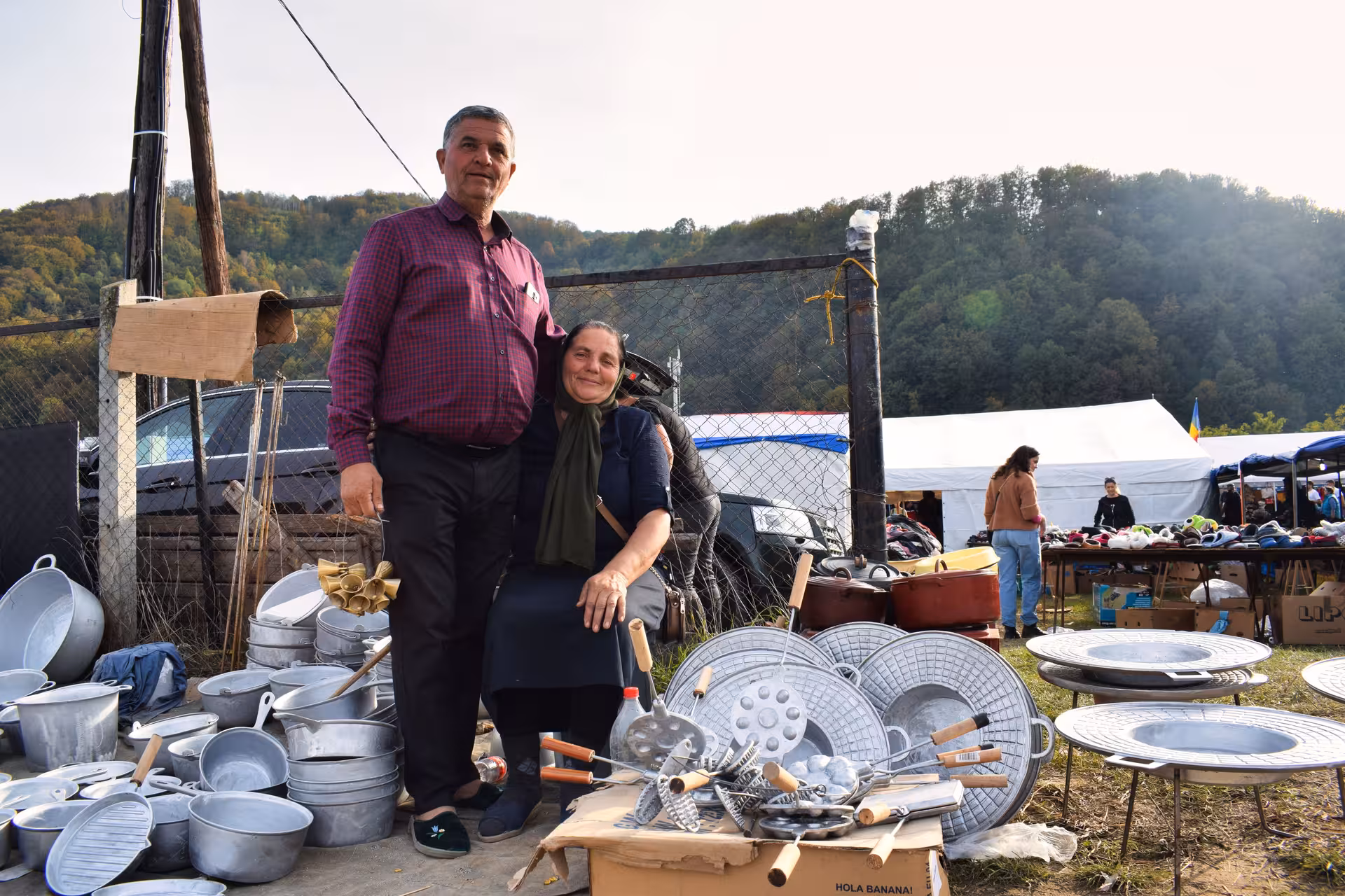 Local vendors selling traditional handcrafted cookware and metal goods at the Negreni antique flea market Romania