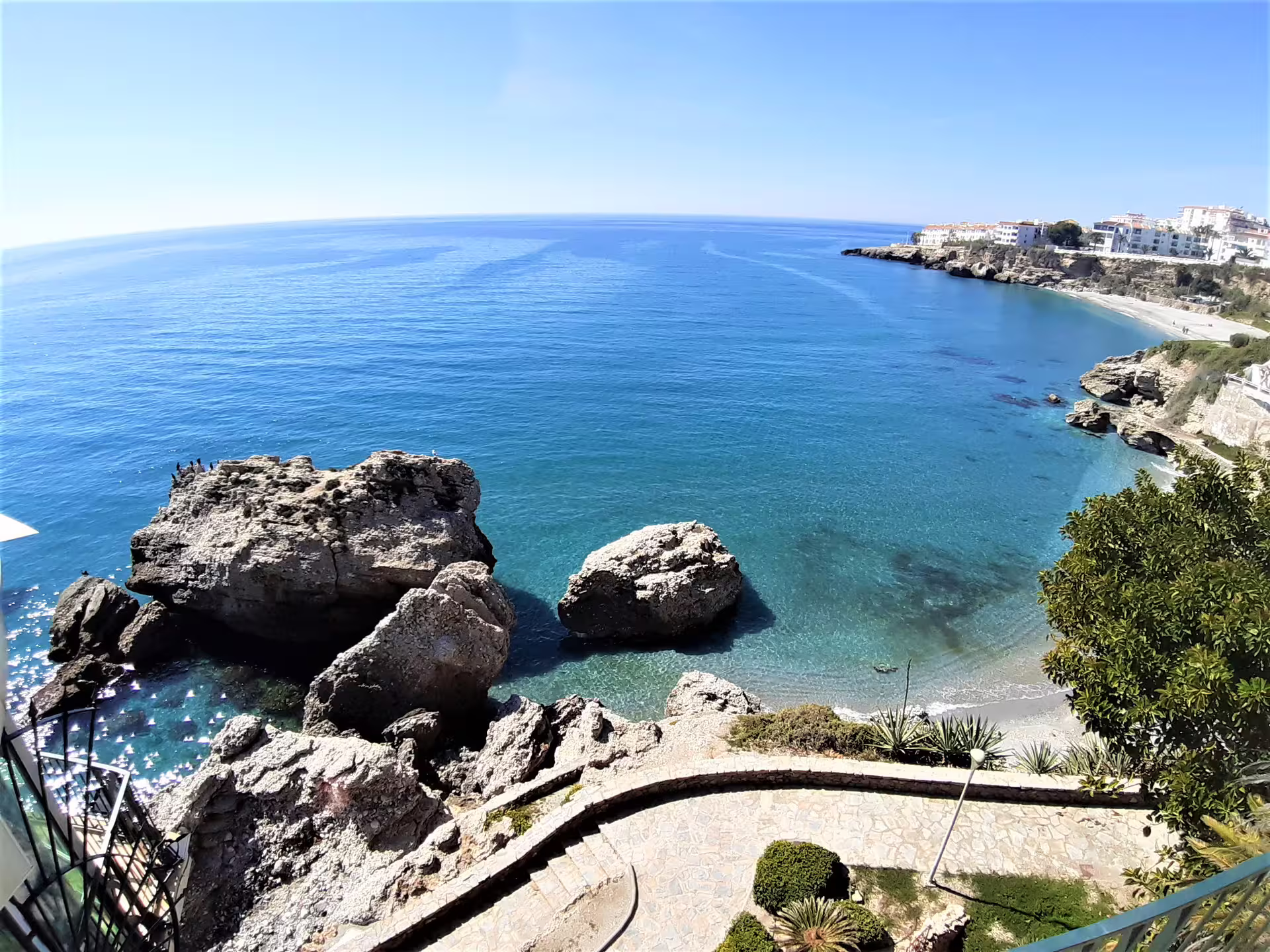 Panoramic Nerja coastline with turquoise sea and rocky coves, seen on a private Marbella pickup day tour
