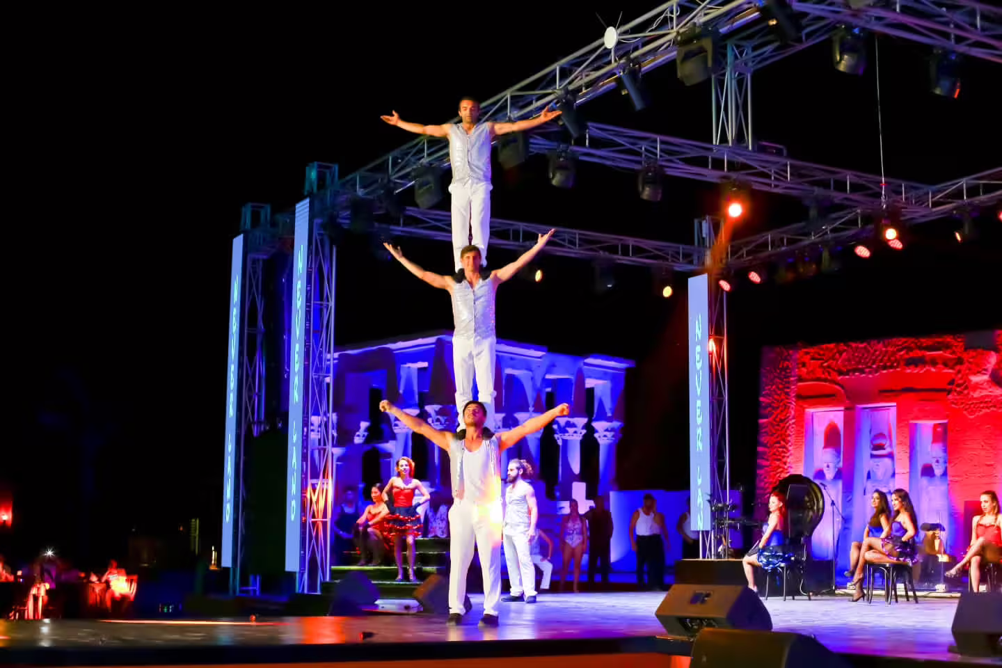 Acrobats form a human tower during Neverland Musical and Cabaret Show, showcasing thrilling live stage acts