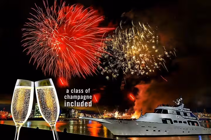 New Year's Eve yacht cruise with fireworks display over harbor and two champagne glasses