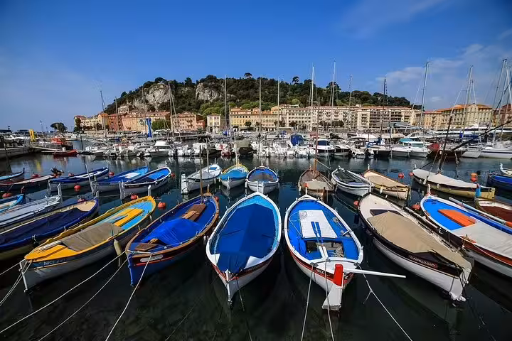 Colorful boats in Nice harbor near Castle Hill, a highlight stop on Place Massena private car tour