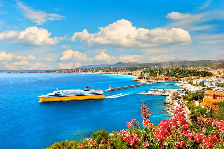 Yellow ferry departing Nice harbor on the French Riviera with turquoise Mediterranean waters and coastal cityscape