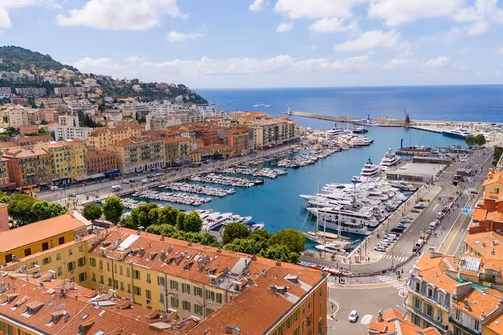 Aerial view of Nice harbor marina with colorful buildings and yachts along the French Riviera coastline