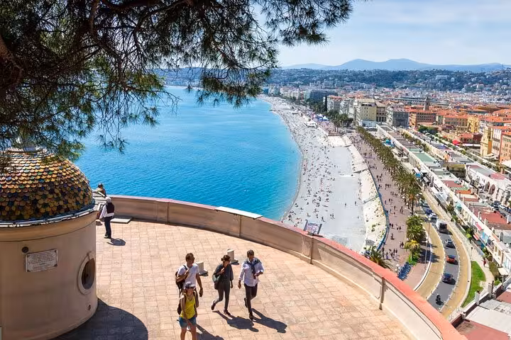 Panoramic view of Nice coastline and Promenade des Anglais from Castle Hill overlook with tourists