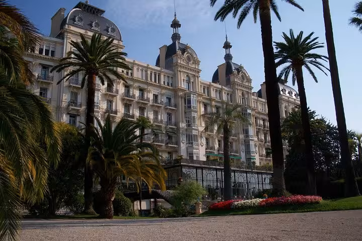 Elegant historic building surrounded by palm trees and gardens in Nice, showcasing the charm of a private city tour.