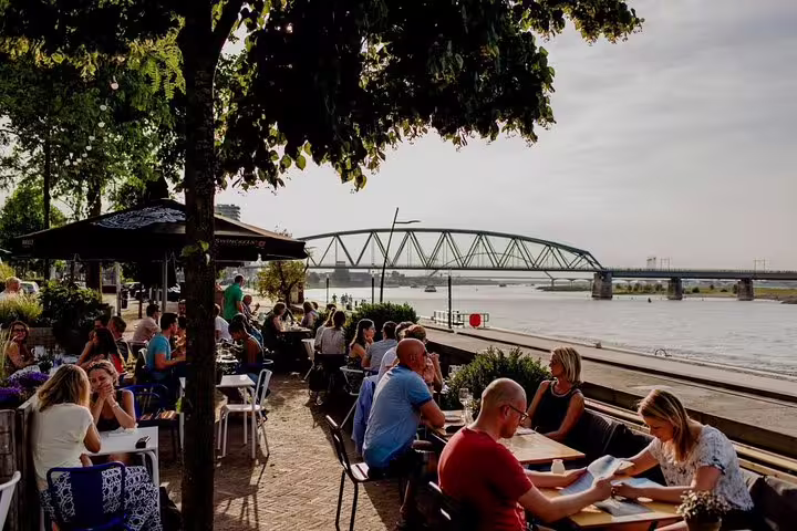Riverside terrace by the Waalbrug in Nijmegen, a scenic stop on the self-guided e-scavenger hunt tour