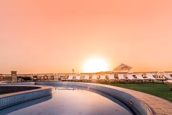 Sunset rooftop pool on Nile cruise ship deck, relaxing stop on 4-day Aswan to Luxor itinerary