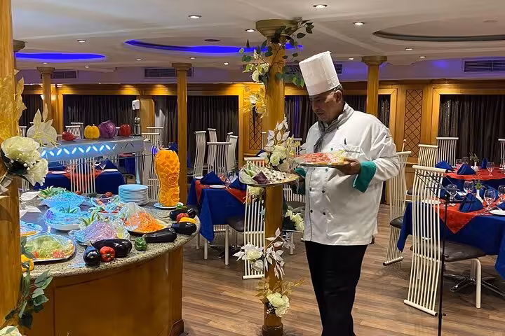 Chef serving buffet dinner on luxury Nile cruise, 4-day Aswan to Luxor trip with Abu Simbel and balloons