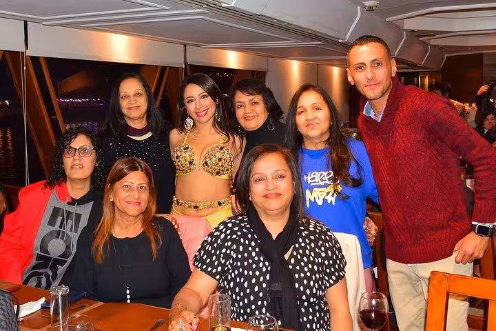 Guests enjoying a lively evening with a belly dancer aboard the Nile Cruise dinner show.