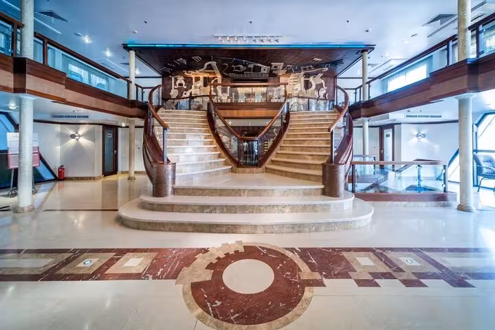 Elegant Nile cruise ship lobby with grand staircase, part of 5-day Luxor Aswan cruise and Abu Simbel tour
