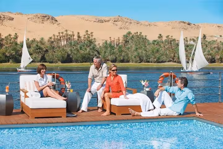 Sun deck pool on Nile cruise with guests relaxing and felucca views on 5-day 4-night Luxor to Aswan trip