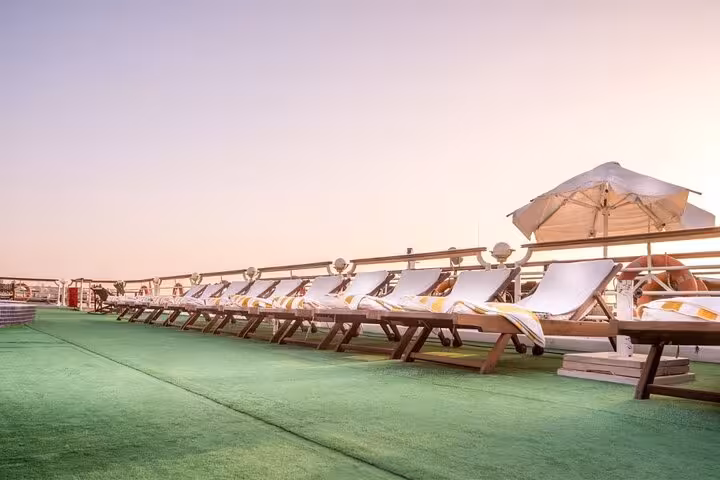 Sun loungers on Nile cruise sundeck at dusk, luxury 5-day Luxor Aswan itinerary with Abu Simbel