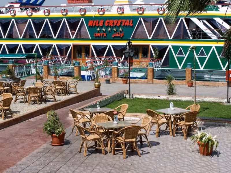 Outdoor seating area beside Nile Crystal cruise boat in Cairo, ideal for dinner cruise with belly dancing and hotel pickup