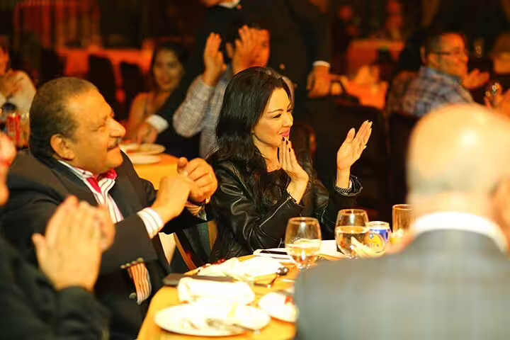 Guests applaud live entertainment during Nile dinner cruise in Cairo, part of Egyptian Museum and Citadel tour