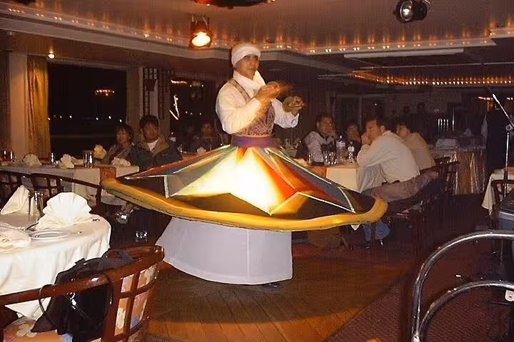 Tanoura dancer performing on a Nile River dinner cruise in Cairo with live traditional music and dining