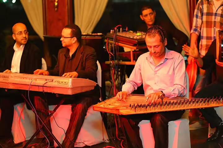 Live band on Nile Maxim dinner cruise in Cairo, musicians playing qanun and keyboard for oriental show