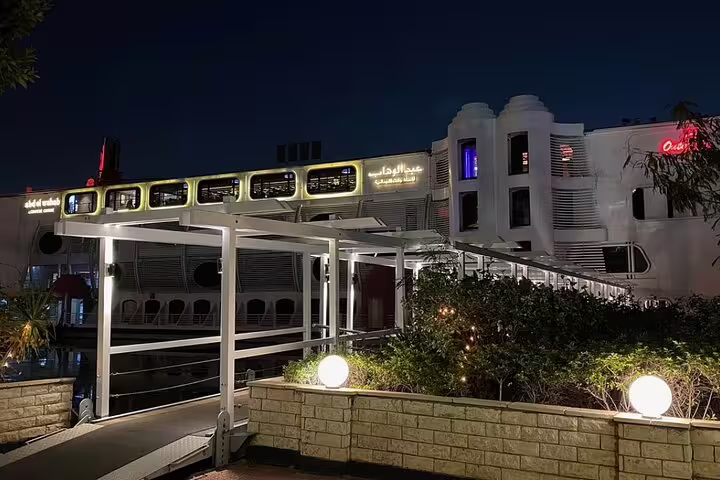 Nile Maxim dinner cruise boat docked in Cairo at night, luxury Nile River dining and show experience