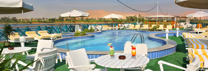 Nile Pearl 5-star Nile cruise sun deck pool with loungers and cocktails, relaxing sail between Luxor and Aswan