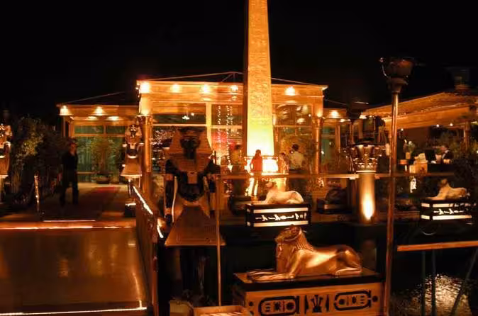 Night deck on Nile Pharaohs cruise with pharaonic statues and warm lighting, luxury Nile River cruise booking