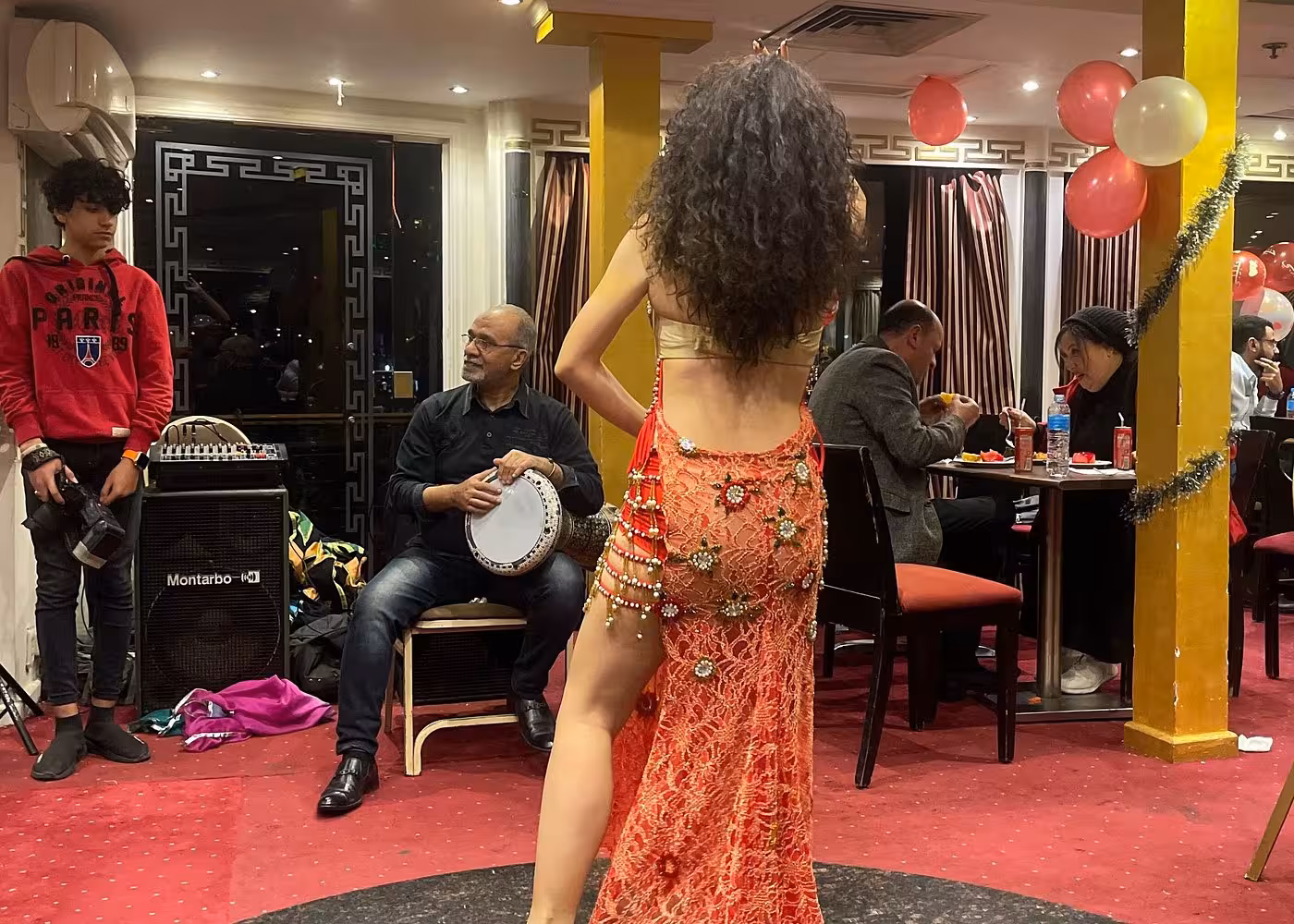 Belly dancer and tabla drummer perform during Nile River night dinner cruise in Cairo with buffet dinner