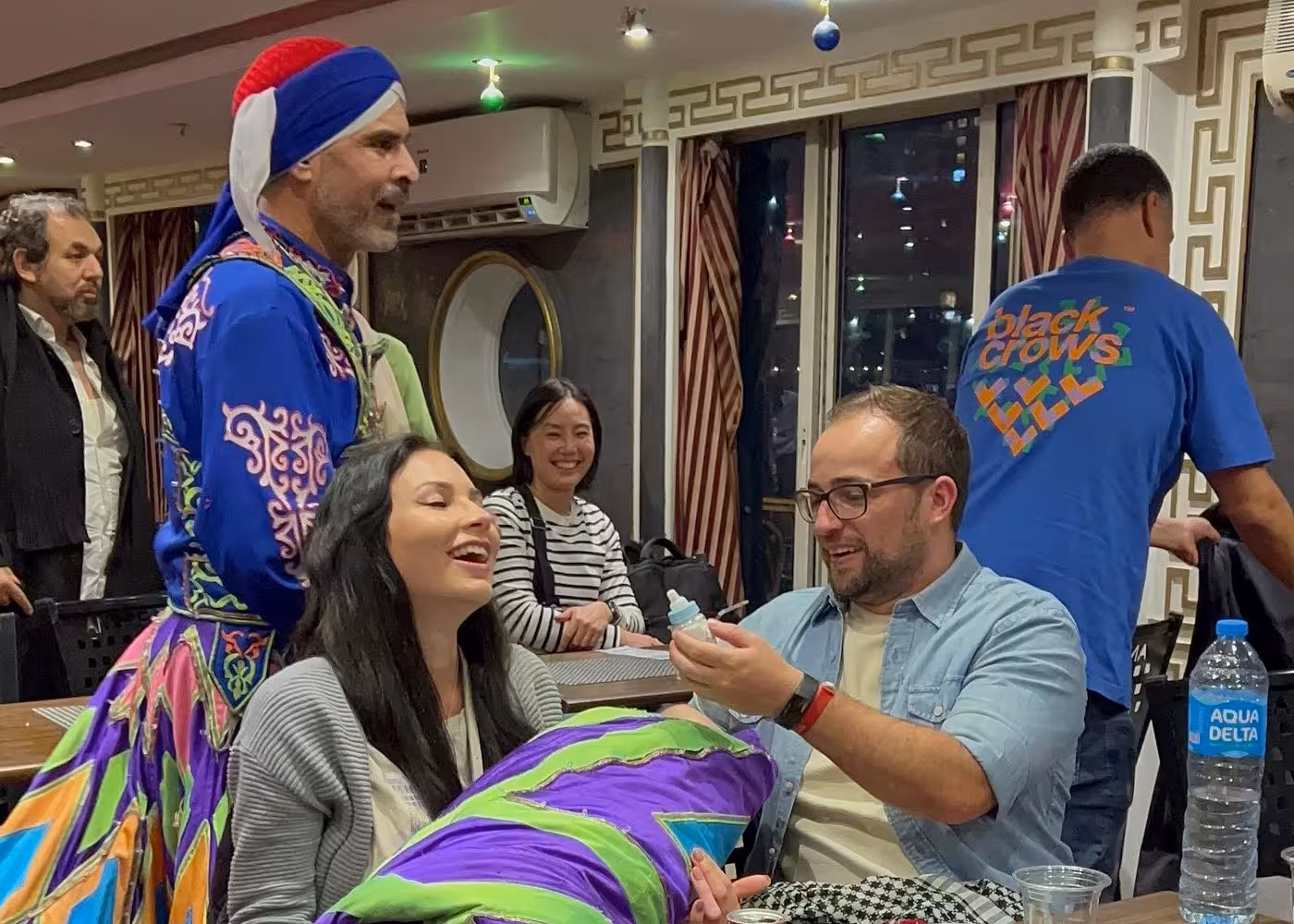 Guests enjoy live Tanoura dance show during Nile River night dinner cruise in Cairo with onboard dining