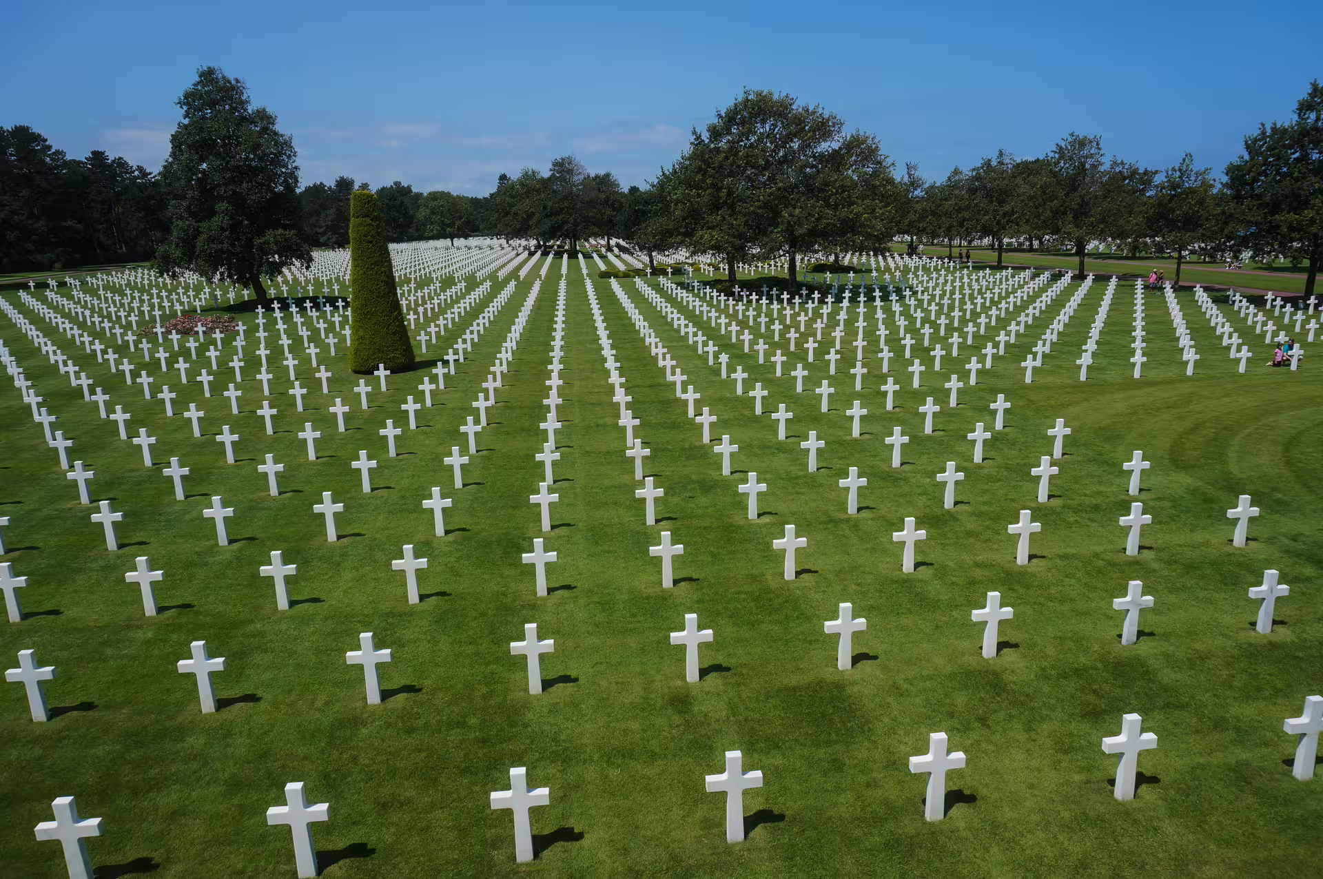 Rows of white crosses at Normandy American Cemetery on a sunny day, Colleville-sur-Mer, France