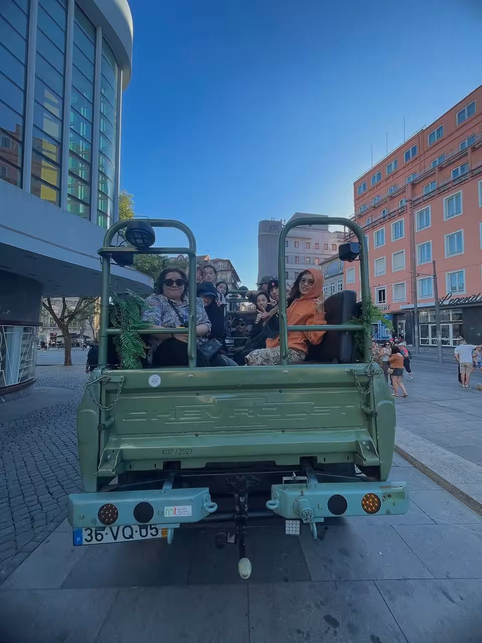 Travelers riding an open-top jeep through city streets on the North Coast Adventure tour, culture and history
