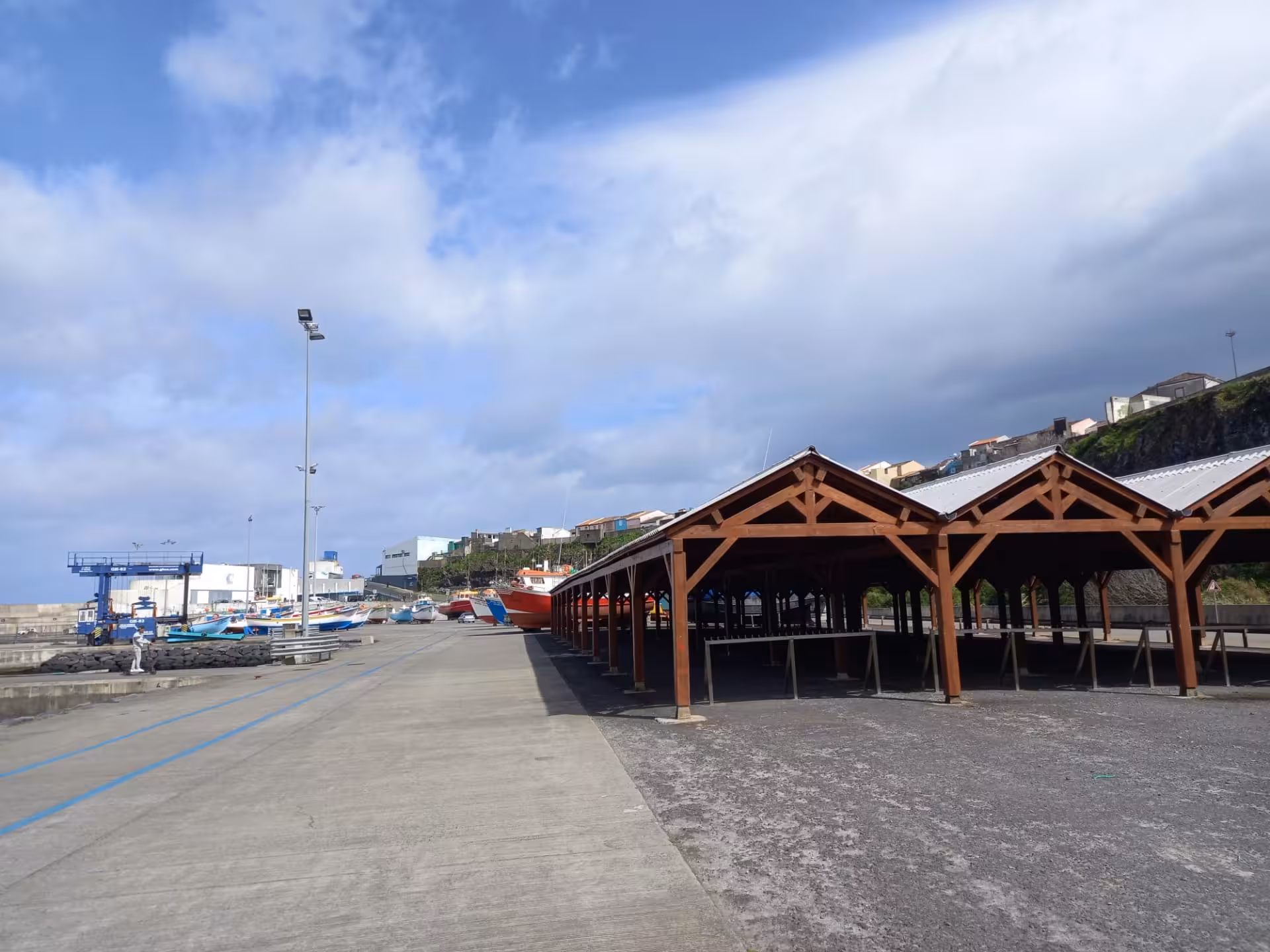 North coast harbor meeting point with boats and wooden shelter before whale watching expedition, transportation not included