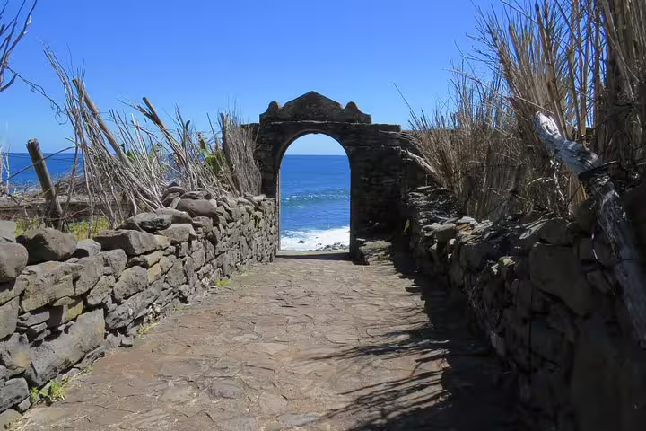 Stone archway with ocean view in Caniçal, showcasing the stunning coastal scenery of the Northeast tour.