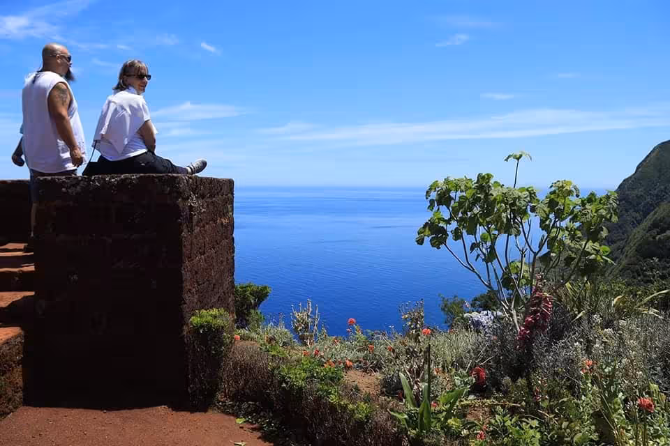 Couple at coastal lookout on Northeast van scenic tour, full-day settlement trip with Atlantic ocean views