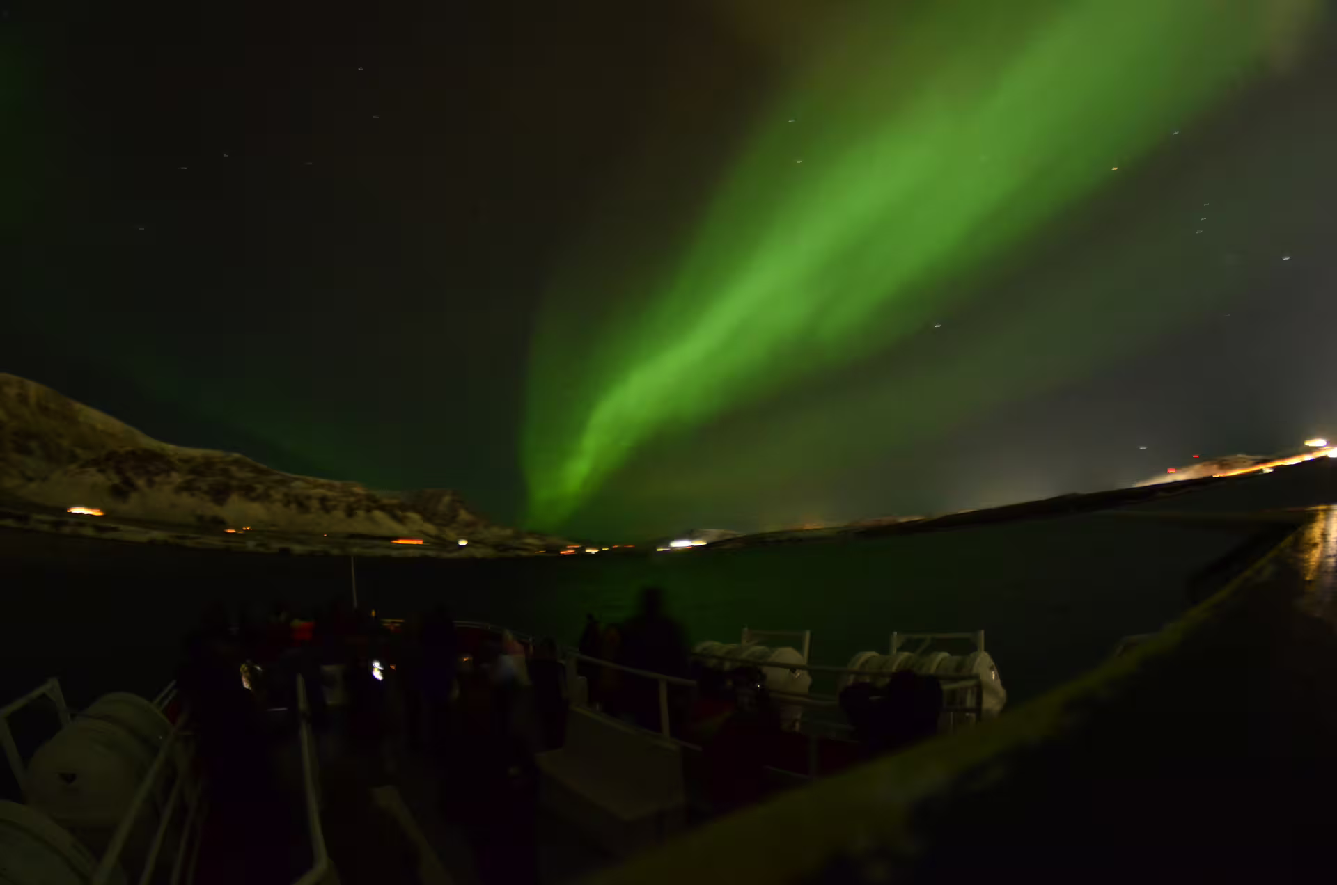 Northern lights aurora borealis viewed from a boat deck in Reykjavik Bay at night