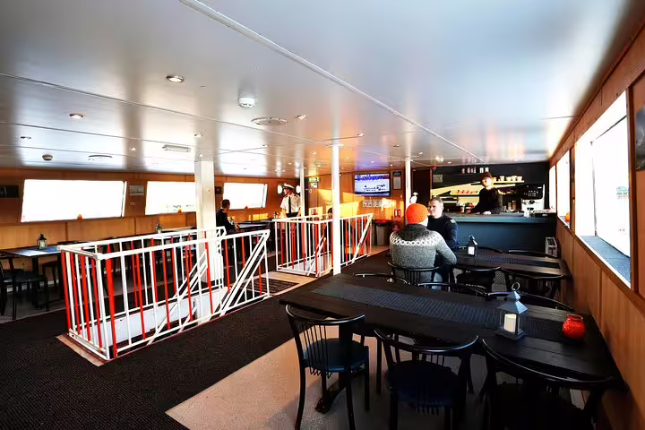 Indoor lounge and bar area of a Northern Lights boat cruise ship in Reykjavik