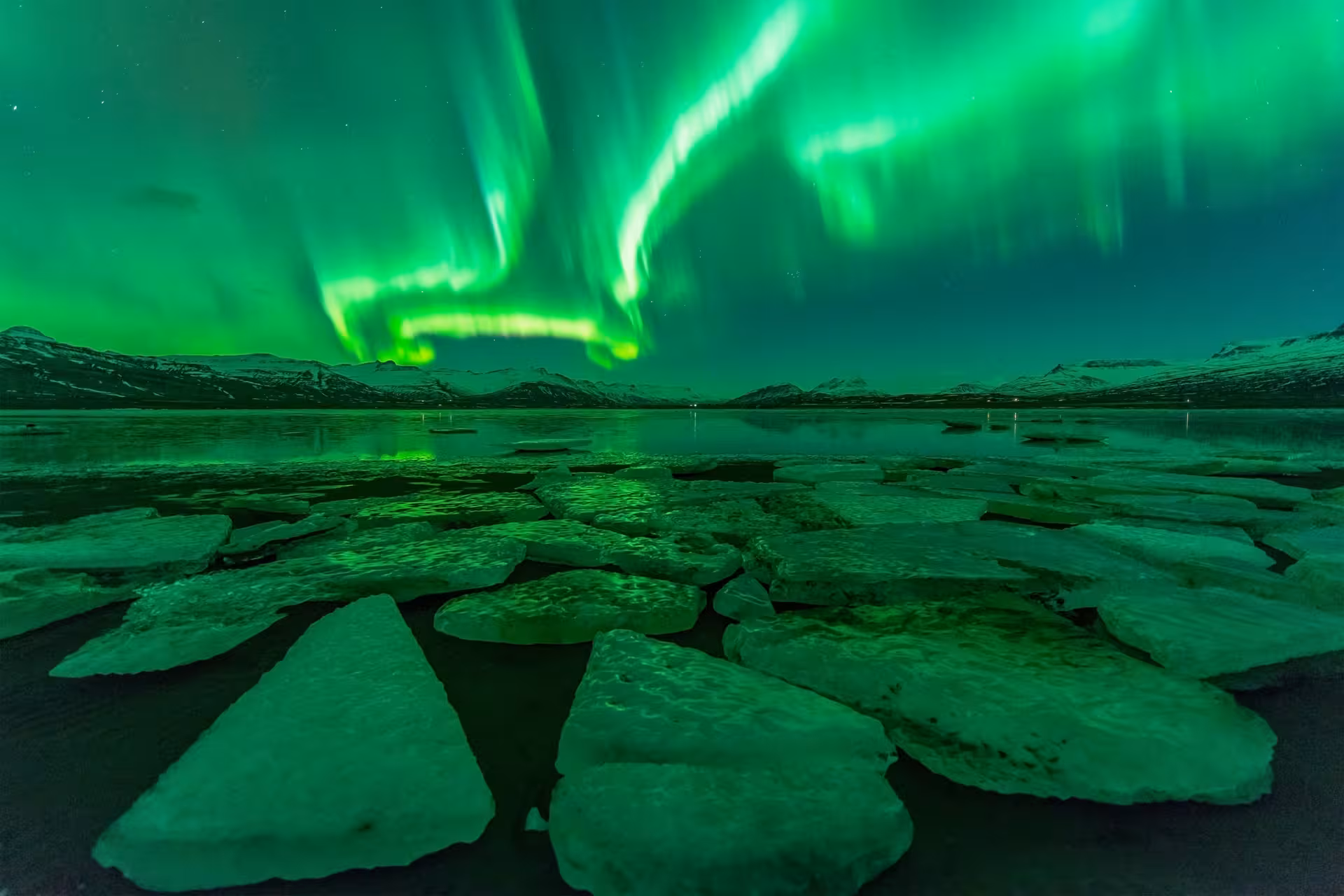 Stunning Northern Lights dance over icy landscape at Glacier Lagoon during the 3-Day Northern Lights Hunt Tour.