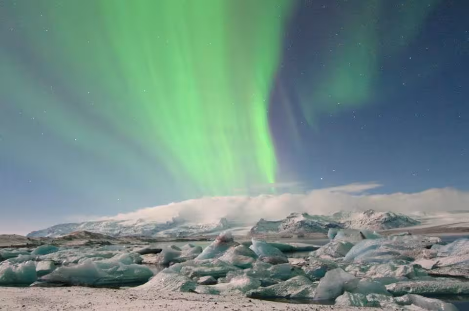 Aurora borealis northern lights dancing over icy Jokulsarlon Glacier Lagoon at night
