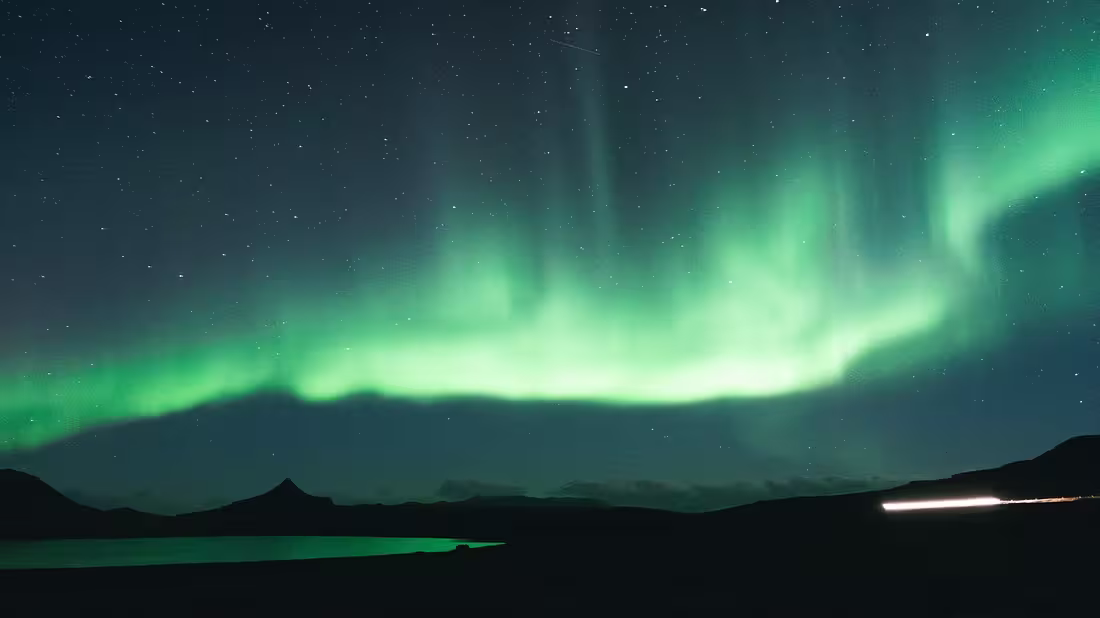 Northern Lights in the night's sky over some mountains