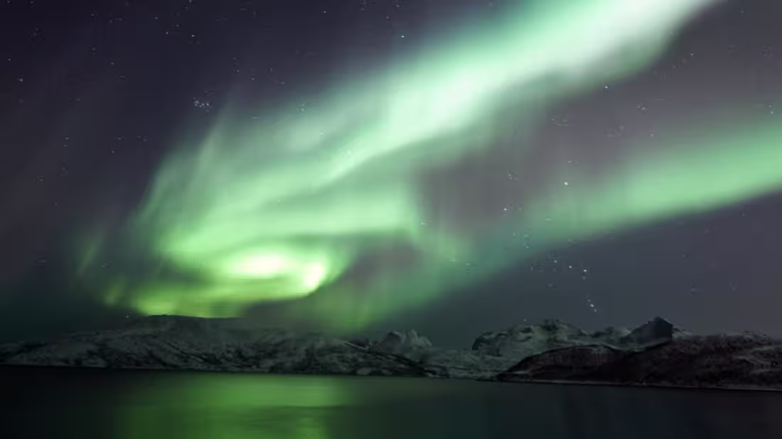 Northern Lights in the night's sky over some mountains