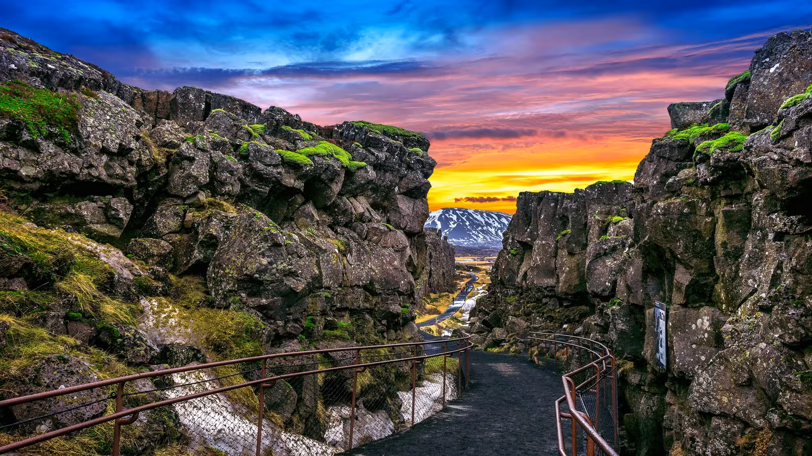 Vibrant sunset over Þingvellir National Park's rugged landscape, highlighting Iceland's unique geology.