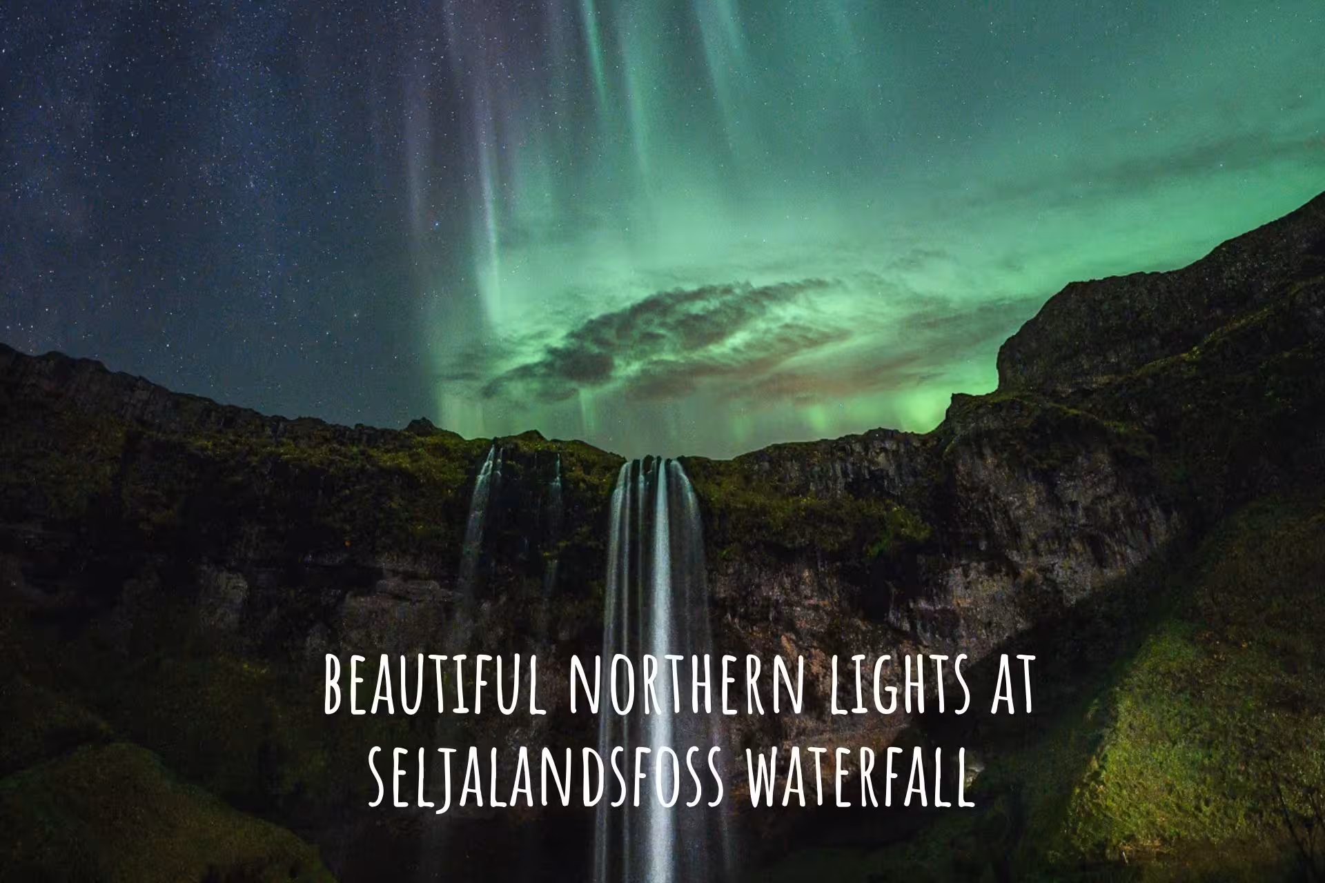 Northern lights aurora borealis over Seljalandsfoss waterfall in South Iceland at night