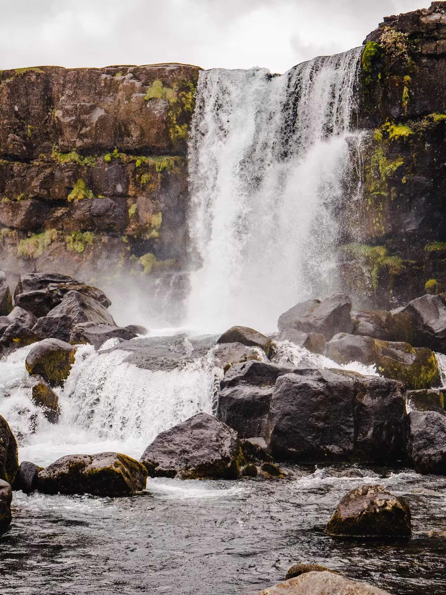 Majestic waterfall cascading over rocks, a highlight of the Private Northern Lights by Super Truck 4x4 tour.