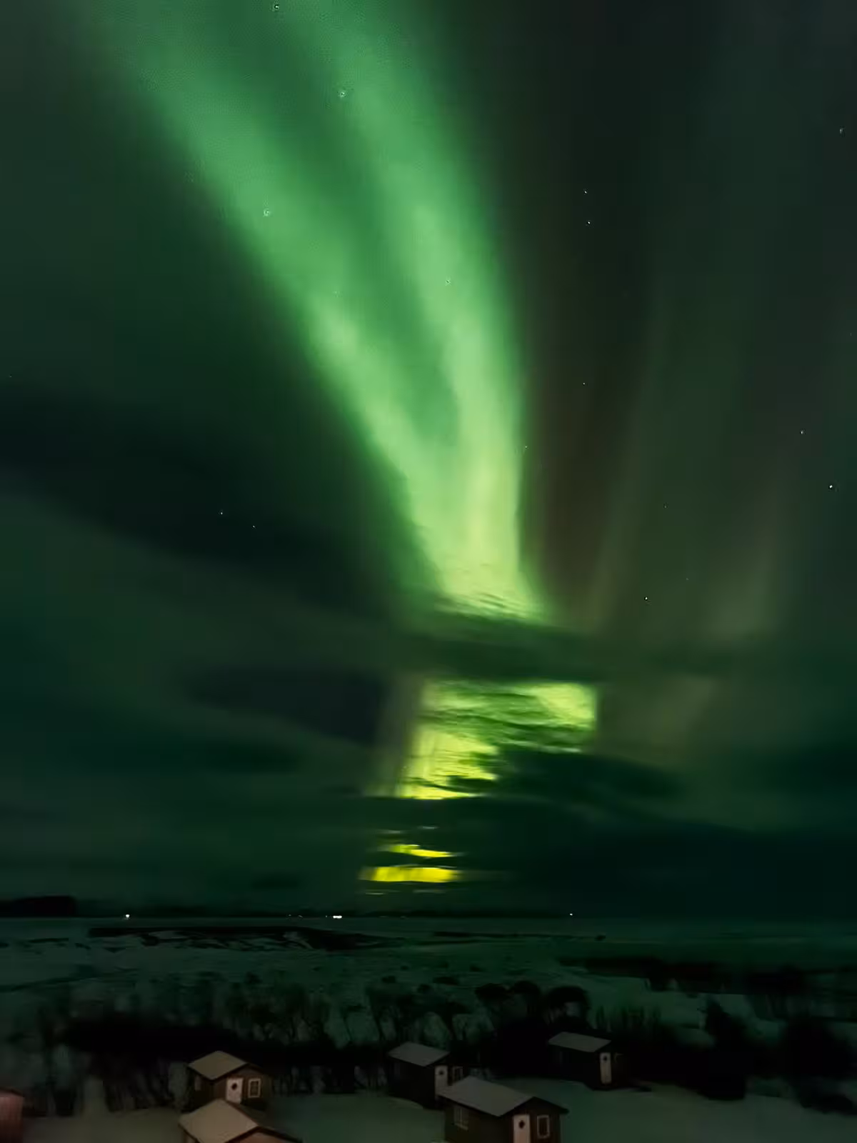 Breathtaking Northern Lights over snowy landscape on a women-only winter adventure with Viking Women.
